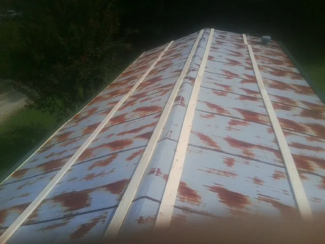 Rusted metal roof panels with new wood purlins before replacement — Storm Damage Roof Repair in Perris by Roofing Brothers