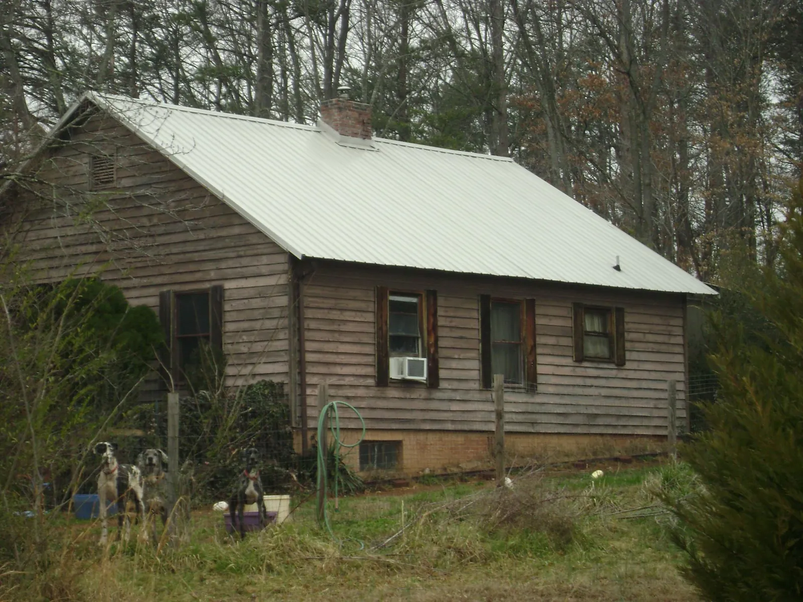 White metal roof on an old wood sided farmhouse, from a Metal Roof Installation job in Perris
